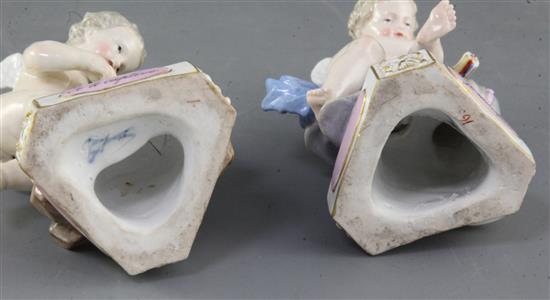 A pair of Meissen figures of Cupids, 19th century, height 11.8cm and 12.5cm